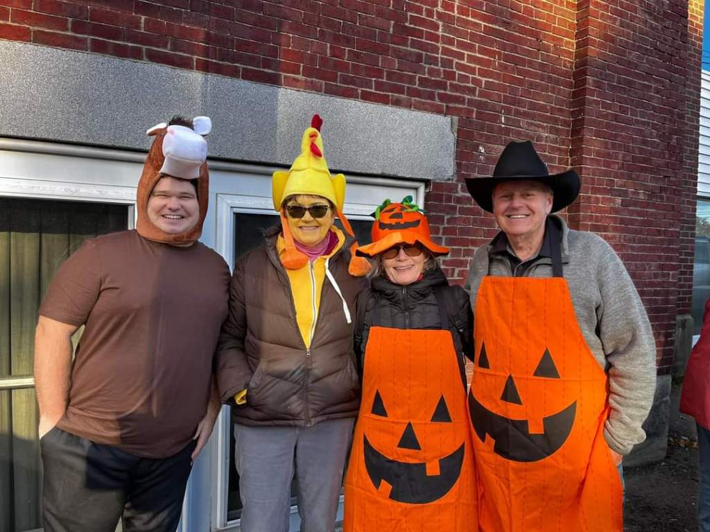 Volunteers dressed up as pumpkins for Trunk or Treat